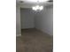 An open dining room with carpeted floors and a simple light fixture at 2842 Jordan Forest Trail Northwest, Lawrenceville, GA 30044