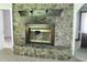 A close-up view of the living room's large stone fireplace with a wood mantel at 2842 Jordan Forest Trail Northwest, Lawrenceville, GA 30044