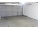 An empty garage with an automatic gray garage door at 2842 Jordan Forest Trail Northwest, Lawrenceville, GA 30044