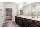 Spacious bathroom featuring double sinks with a dark wood vanity and hardwood floors, adjoins a bedroom at 111 Point View Dr, Canton, GA 30114