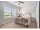 Bedroom with a ceiling fan and a large window with shutter blinds at 111 Point View Dr, Canton, GA 30114