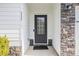 Close-up of the elegant front door with stone and white trim, creating a stylish entry at 111 Point View Dr, Canton, GA 30114