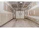 Empty garage interior with bare walls, concrete floor and a white sectional door at 111 Point View Dr, Canton, GA 30114