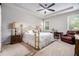 Spacious bedroom with ceiling fan, windows, and a sitting area at 111 Point View Dr, Canton, GA 30114