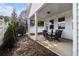 Covered patio with a dining table and chairs, landscaping and a white fence at 111 Point View Dr, Canton, GA 30114