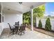 Back patio features a white fence, evergreen landscaping, and a table for four at 111 Point View Dr, Canton, GA 30114