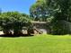 Back of the house with steps to the deck, a manicured lawn and trees at 2832 Jordan Forest Trail Northwest, Lawrenceville, GA 30044