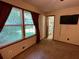 Bedroom features carpet, neutral walls, two windows with red curtains, and a mounted TV at 2832 Jordan Forest Trail Northwest, Lawrenceville, GA 30044