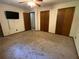 Carpeted bedroom with ceiling fan, TV and dual closets at 2832 Jordan Forest Trail Northwest, Lawrenceville, GA 30044