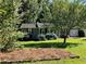 Charming home with a landscaped front yard, mature trees, and a well-maintained lawn at 2832 Jordan Forest Trail Northwest, Lawrenceville, GA 30044