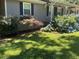 Landscaped front yard features a manicured lawn, plants, and shrubbery at 2832 Jordan Forest Trail Northwest, Lawrenceville, GA 30044