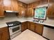 Cozy kitchen featuring wooden cabinets, stainless steel appliances, and natural light at 2832 Jordan Forest Trail Northwest, Lawrenceville, GA 30044