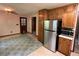 Eat-in kitchen featuring stainless steel refrigerator, cabinetry and adjacent room at 2832 Jordan Forest Trail Northwest, Lawrenceville, GA 30044
