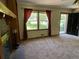 Living room features brick fireplace, large window, and entry to front door at 2832 Jordan Forest Trail Northwest, Lawrenceville, GA 30044