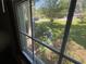 Window view of a yard with green grass, trees, and flowering bushes at 2832 Jordan Forest Trail Northwest, Lawrenceville, GA 30044