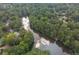 Scenic aerial view of a lake surrounded by lush trees at 3375 Rivendell Ct, Roswell, GA 30075