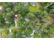 Aerial view of a home surrounded by mature trees in a neighborhood setting at 3375 Rivendell Ct, Roswell, GA 30075