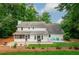 White two-story home with a screened porch, patio, and ample backyard space at 3375 Rivendell Ct, Roswell, GA 30075