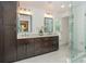 Elegant bathroom featuring marble floors, a double vanity with dark cabinets, and a glass-enclosed shower at 3375 Rivendell Ct, Roswell, GA 30075
