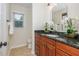 Bathroom featuring a vanity with wood cabinets, granite countertops, and a decorative oval mirror at 3375 Rivendell Ct, Roswell, GA 30075