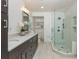 Stylish bathroom with a double sink vanity, marble floors, and a modern glass-enclosed shower at 3375 Rivendell Ct, Roswell, GA 30075