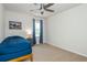 Minimalist bedroom with a simple bed, blue curtains, and a small nightstand for a cozy space at 3375 Rivendell Ct, Roswell, GA 30075