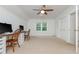 Spacious bonus room with carpeted floors, natural light, ceiling fan, and two desk areas at 3375 Rivendell Ct, Roswell, GA 30075