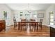 A well-lit dining room with a wood table, hardwood floors, and natural light at 3375 Rivendell Ct, Roswell, GA 30075