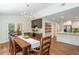 Dining room with dining table, access to screened in porch, and butler's pantry with coffee station at 3375 Rivendell Ct, Roswell, GA 30075