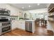 Modern kitchen features stainless steel appliances and eat-in dining area at 3375 Rivendell Ct, Roswell, GA 30075
