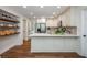 A spacious, open kitchen with hardwood floors, an island, and open shelving at 3375 Rivendell Ct, Roswell, GA 30075