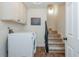 Laundry room with washer/dryer, storage cabinets, and access to the stairs at 3375 Rivendell Ct, Roswell, GA 30075