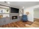 Cozy living room with a fireplace, built-in shelves, and hardwood floors at 3375 Rivendell Ct, Roswell, GA 30075