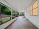 Covered back porch with brick flooring that has windows and a view of the green backyard at 3997 Paloverde Nw Dr, Kennesaw, GA 30144