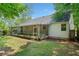The backyard features a screened in porch, mature trees, and green grass at 3997 Paloverde Nw Dr, Kennesaw, GA 30144