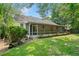 The backyard features a screened in porch, mature trees, and green grass at 3997 Paloverde Nw Dr, Kennesaw, GA 30144