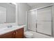 Bathroom with tub/shower, white sink, and white toilet next to wood cabinets at 3997 Paloverde Nw Dr, Kennesaw, GA 30144