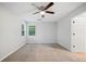 Bedroom with neutral carpet and walls, ceiling fan, and window looking out onto treed exterior at 3997 Paloverde Nw Dr, Kennesaw, GA 30144