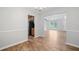 Bright dining area with wood floors and an adjacent kitchen with stainless steel refrigerator and wood cabinets at 3997 Paloverde Nw Dr, Kennesaw, GA 30144