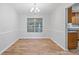 This dining room features wood floors, neutral colored walls, and a chandelier that hangs above at 3997 Paloverde Nw Dr, Kennesaw, GA 30144