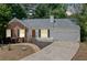 Charming one-story home with brick and vinyl siding, a well-manicured lawn, and a concrete driveway at 3997 Paloverde Nw Dr, Kennesaw, GA 30144