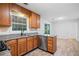 A well-lit kitchen with wooden cabinetry, granite counters, stainless steel appliances, and wood-look floors at 3997 Paloverde Nw Dr, Kennesaw, GA 30144