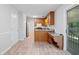 A well-lit kitchen with wooden cabinetry, granite counters, stainless steel appliances, and wood-look floors at 3997 Paloverde Nw Dr, Kennesaw, GA 30144