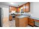 A well-lit kitchen with wooden cabinetry, granite counters, stainless steel appliances, and wood-look floors at 3997 Paloverde Nw Dr, Kennesaw, GA 30144