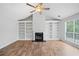 Cozy living room with a fireplace surrounded by built-in bookshelves and bright window at 3997 Paloverde Nw Dr, Kennesaw, GA 30144