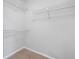 Spacious walk-in closet with shelving and neutral-colored walls for storage and organization at 3997 Paloverde Nw Dr, Kennesaw, GA 30144