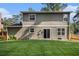 View of the back exterior elevation showing a well-manicured lawn and a patio at 5086 N Woodbridge Trl, Stone Mountain, GA 30088