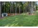 Spacious backyard featuring large lawn, wooded area, and storage shed at 5086 N Woodbridge Trl, Stone Mountain, GA 30088