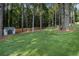This yard has a shed, a forest in the background, and a well-kept lawn at 5086 N Woodbridge Trl, Stone Mountain, GA 30088