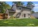 The backyard has a well-manicured lawn, plants, and access to the house through sliding glass doors at 5086 N Woodbridge Trl, Stone Mountain, GA 30088